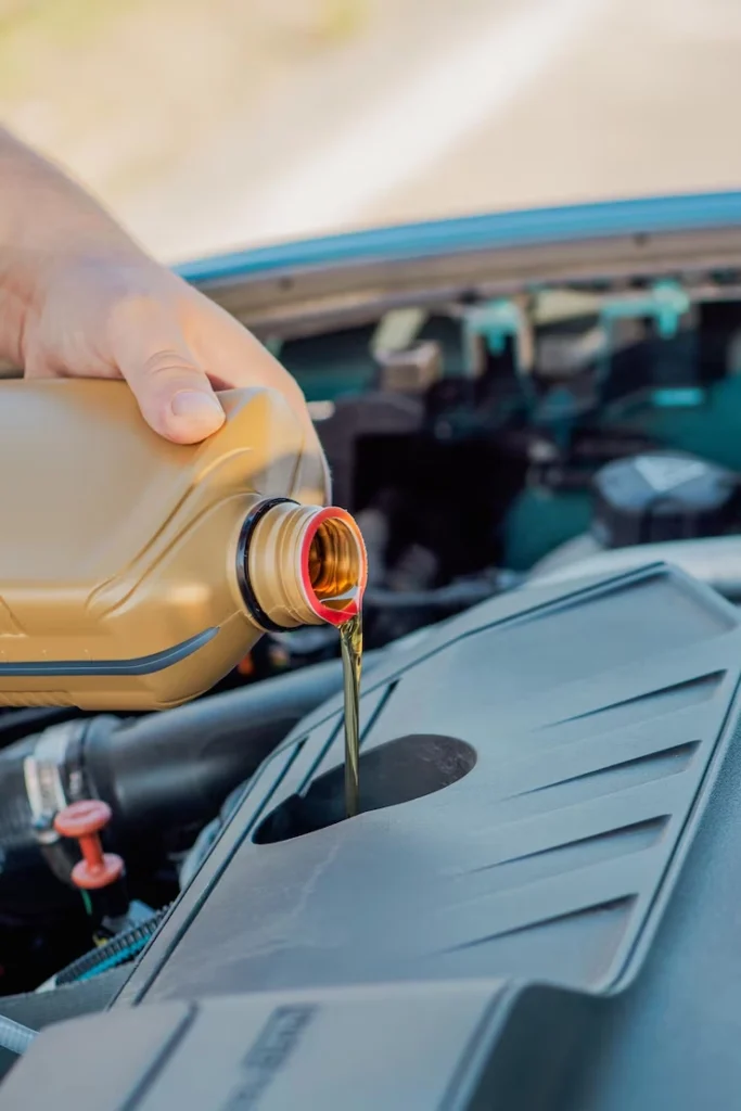 changing car oil pouring fresh lubricant into engine