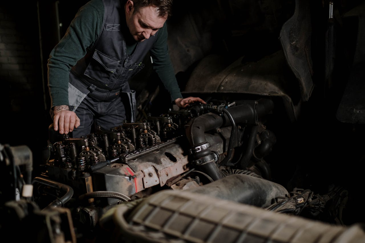 mechanic repairing a truck engine